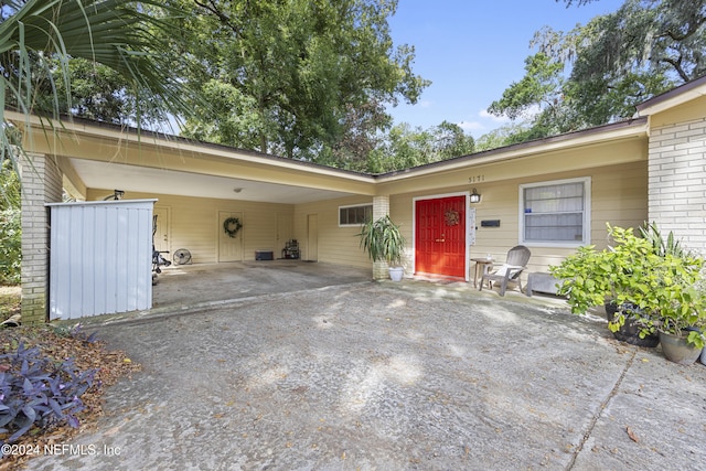 entrance to property featuring a carport