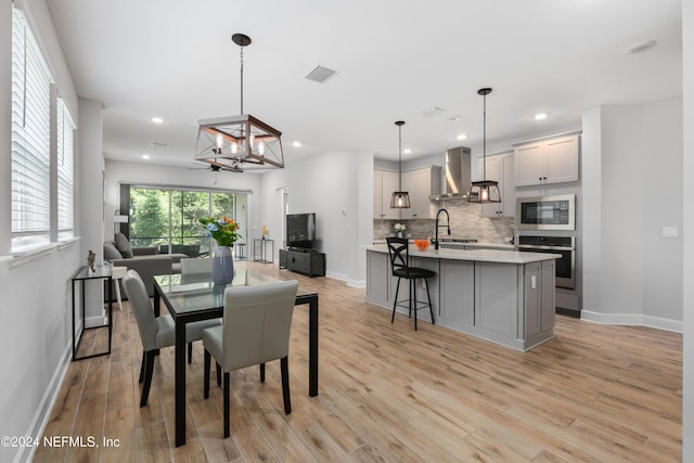 dining area with light hardwood / wood-style flooring and sink