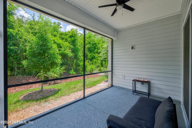 sunroom / solarium featuring ceiling fan