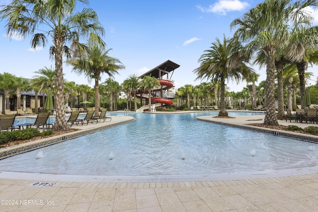 view of pool featuring a patio area and a water slide