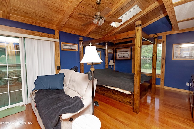 bedroom with access to outside, wood ceiling, hardwood / wood-style floors, lofted ceiling with skylight, and ceiling fan