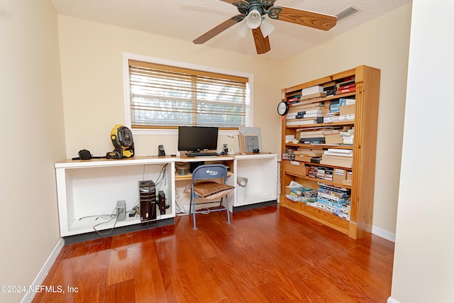 home office featuring hardwood / wood-style floors, a textured ceiling, and ceiling fan