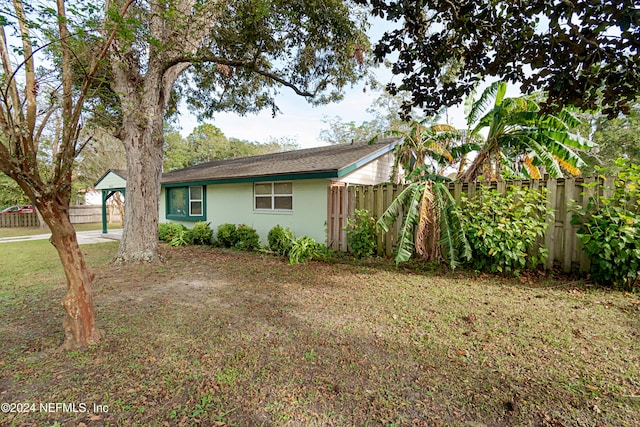 view of side of property with a yard