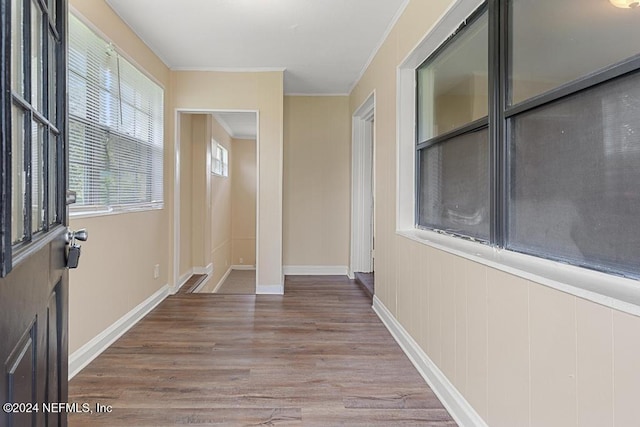 interior space featuring hardwood / wood-style flooring and ornamental molding