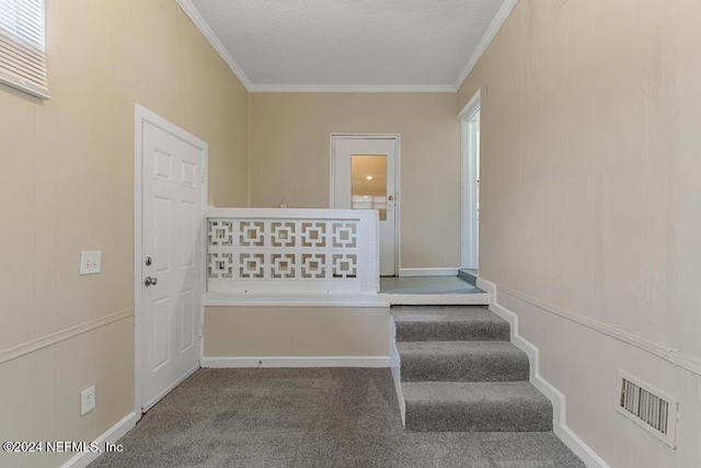 staircase with crown molding and carpet floors