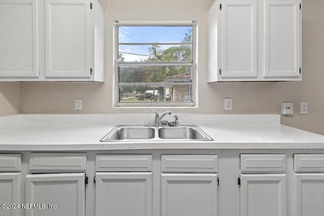 kitchen featuring white cabinetry and sink