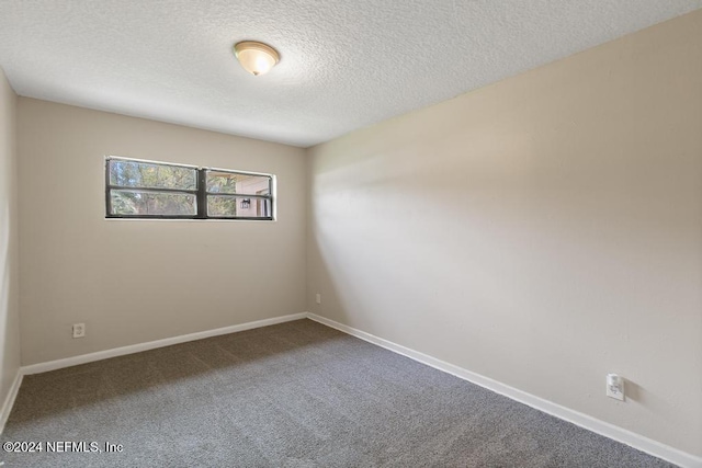 carpeted spare room with a textured ceiling