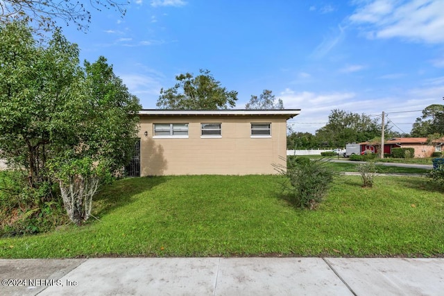 view of side of home featuring a yard