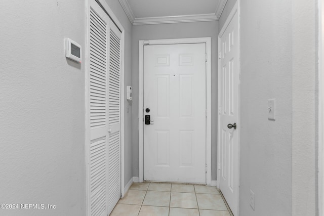 doorway to outside with light tile patterned floors and ornamental molding