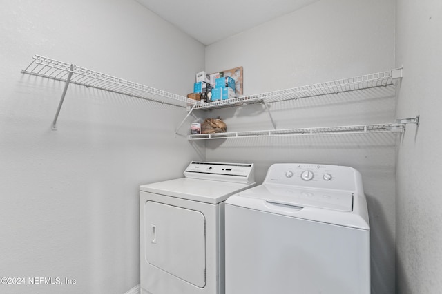 laundry area with laundry area and washer and clothes dryer