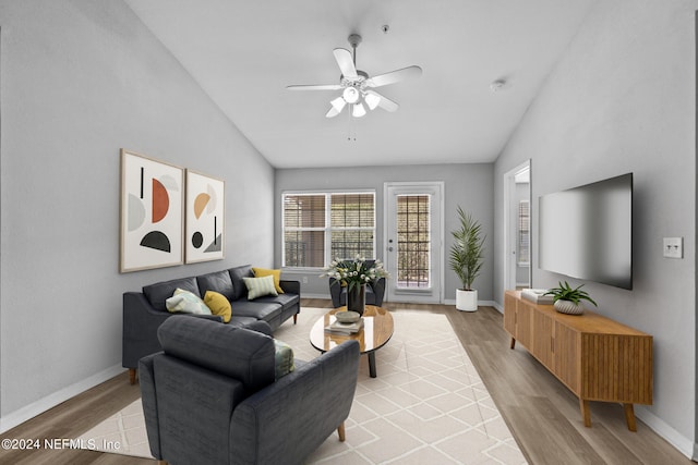 living room featuring light wood-type flooring, vaulted ceiling, and ceiling fan