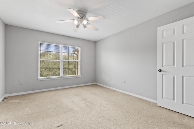 empty room featuring light carpet and ceiling fan