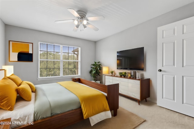 bedroom with light carpet and ceiling fan