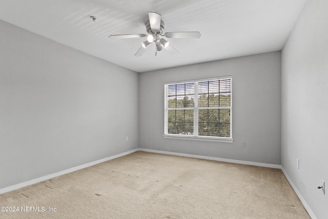 unfurnished room with a ceiling fan, carpet flooring, and baseboards