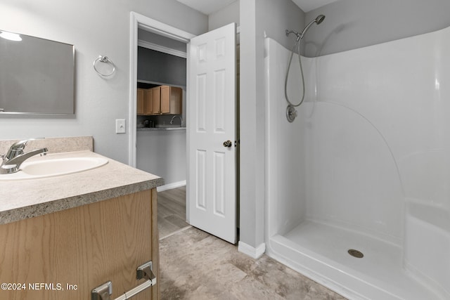 bathroom featuring a stall shower and vanity