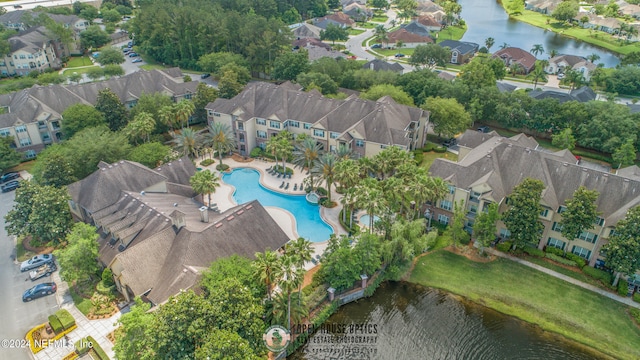 drone / aerial view featuring a water view and a residential view