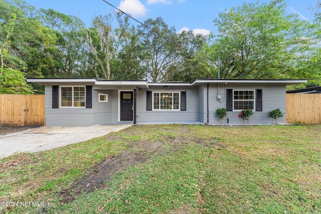 ranch-style home with a front lawn