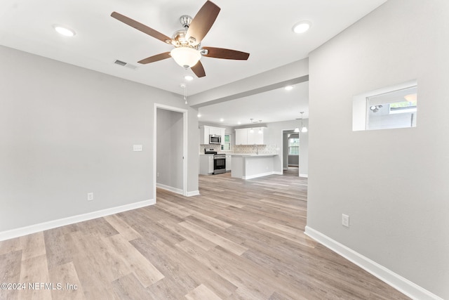 unfurnished living room featuring light wood-type flooring and ceiling fan