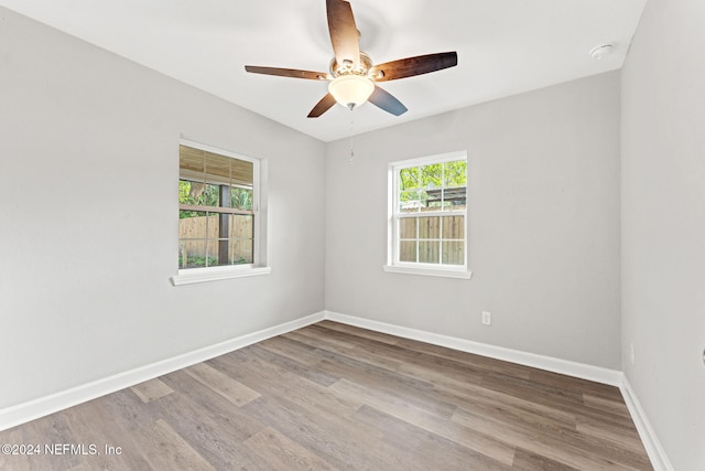 unfurnished room featuring light hardwood / wood-style flooring, ceiling fan, and plenty of natural light