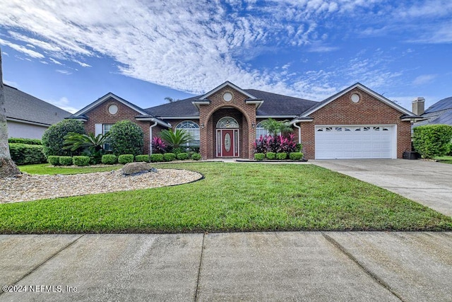 ranch-style house with a front yard and a garage