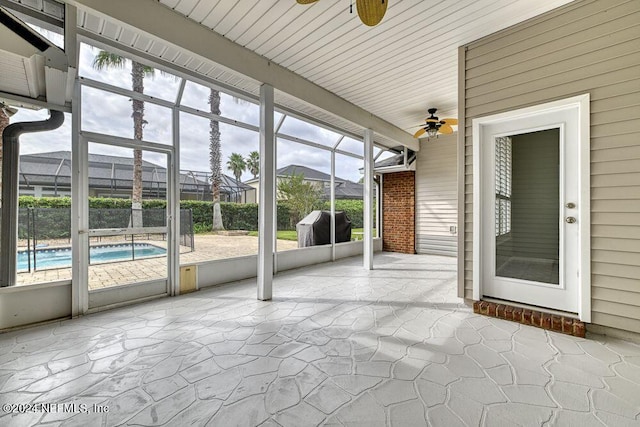 unfurnished sunroom with ceiling fan and a wealth of natural light