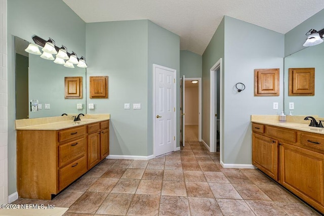 bathroom featuring a textured ceiling and vanity