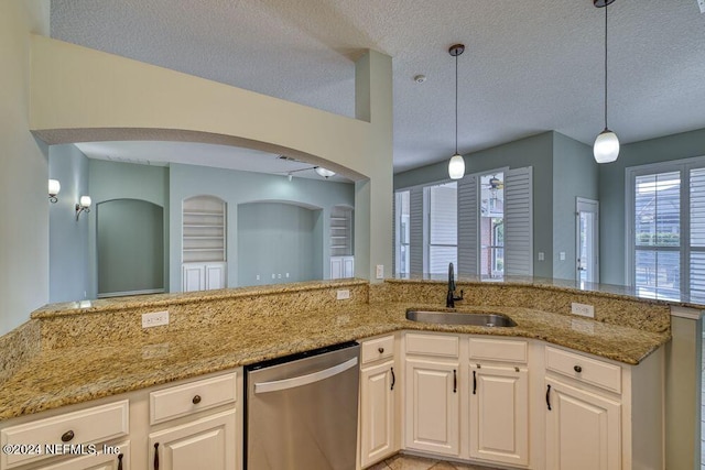 kitchen featuring pendant lighting, a textured ceiling, white cabinets, sink, and stainless steel dishwasher