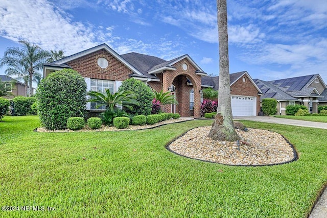 view of front of home with a front yard and a garage