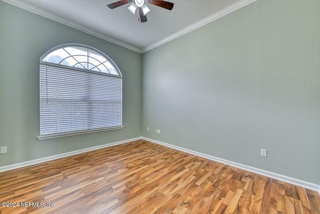 empty room with a textured ceiling, ceiling fan, crown molding, and hardwood / wood-style floors