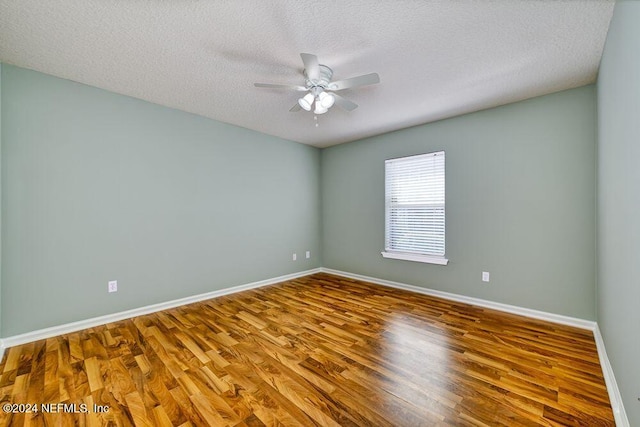 spare room featuring a textured ceiling, ceiling fan, and hardwood / wood-style flooring