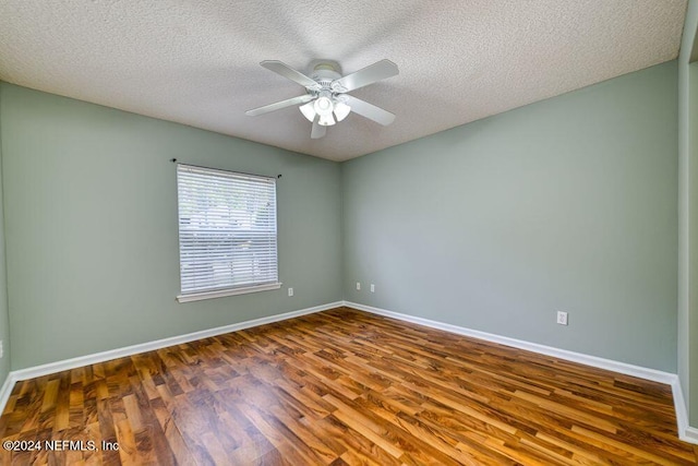 empty room with a textured ceiling, dark wood-type flooring, and ceiling fan