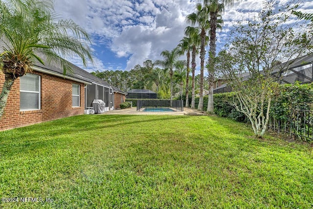 view of yard featuring glass enclosure