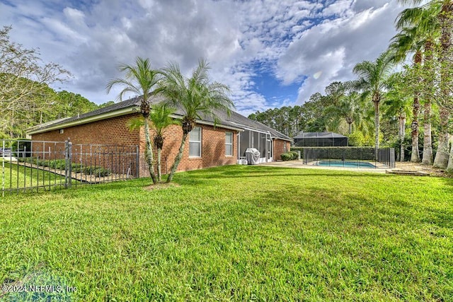 view of yard featuring a lanai and a fenced in pool