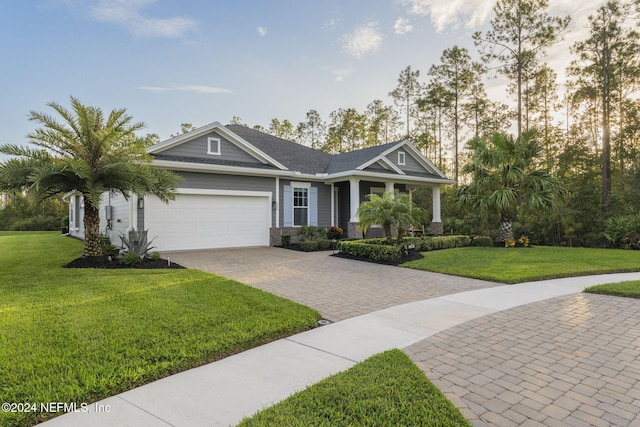 craftsman house with a garage and a front yard