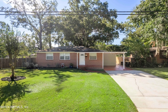 ranch-style home with a carport and a front lawn