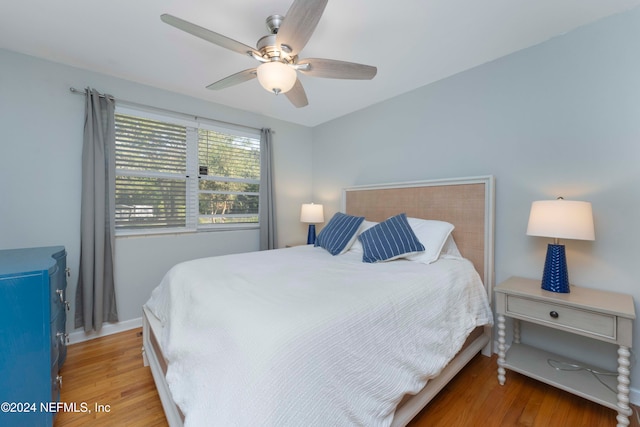 bedroom with hardwood / wood-style floors and ceiling fan