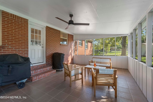 sunroom featuring lofted ceiling and ceiling fan