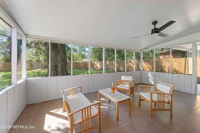 sunroom featuring ceiling fan and plenty of natural light