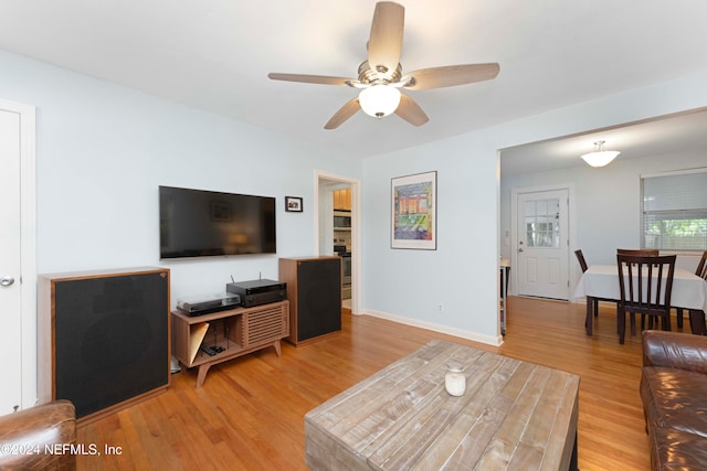 living room featuring hardwood / wood-style flooring and ceiling fan