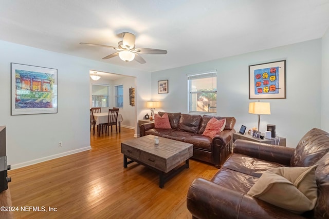 living room featuring light hardwood / wood-style floors and ceiling fan