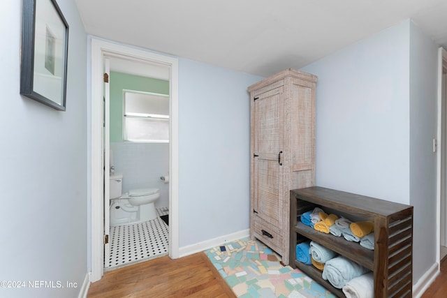 bathroom featuring hardwood / wood-style flooring and toilet