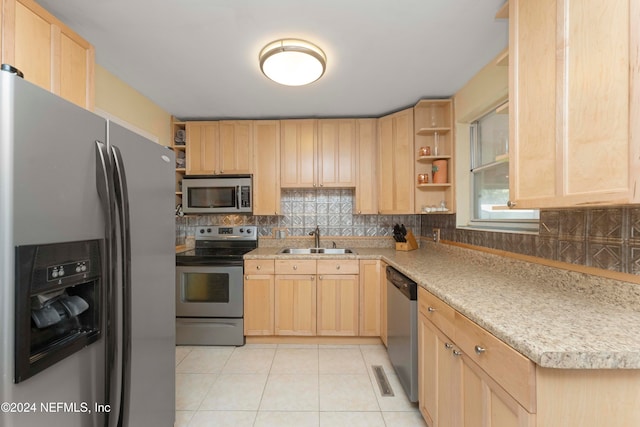 kitchen featuring light brown cabinets, appliances with stainless steel finishes, sink, and light tile patterned flooring