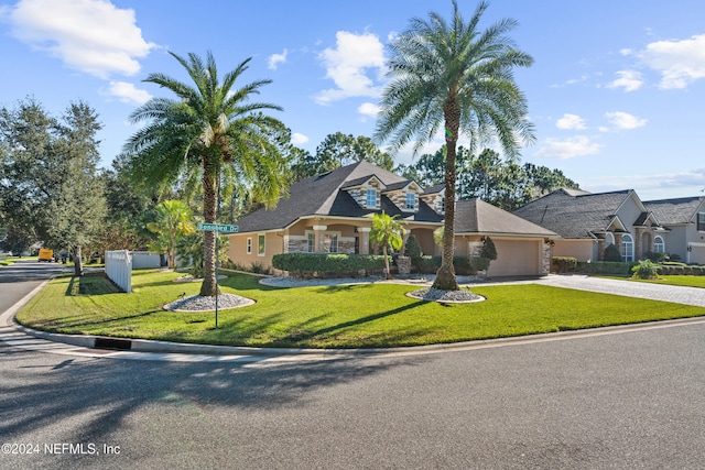 view of front facade featuring a front yard and a garage