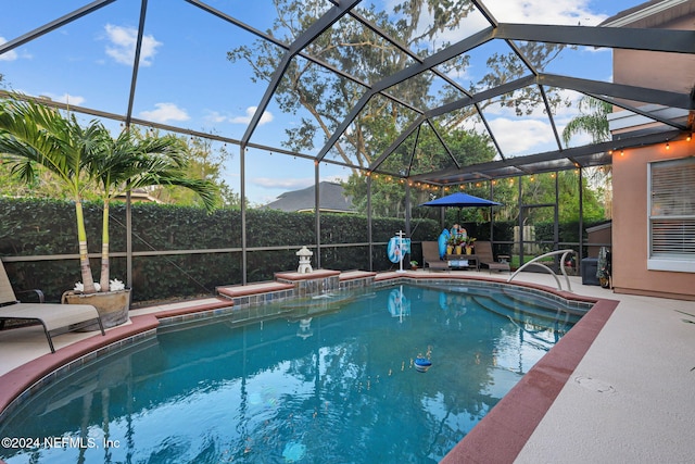 view of swimming pool featuring a mountain view, a patio, and a lanai