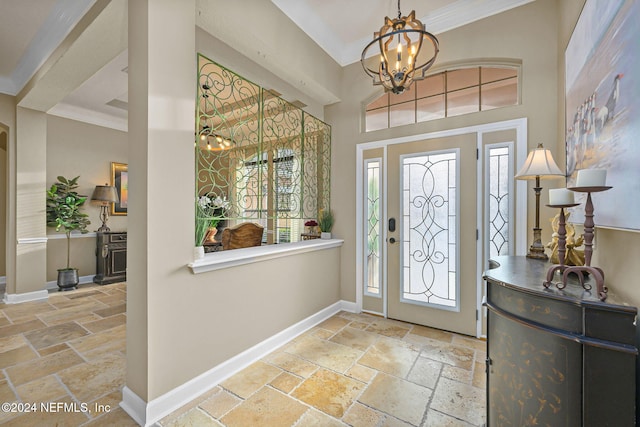 foyer with ornamental molding and a notable chandelier