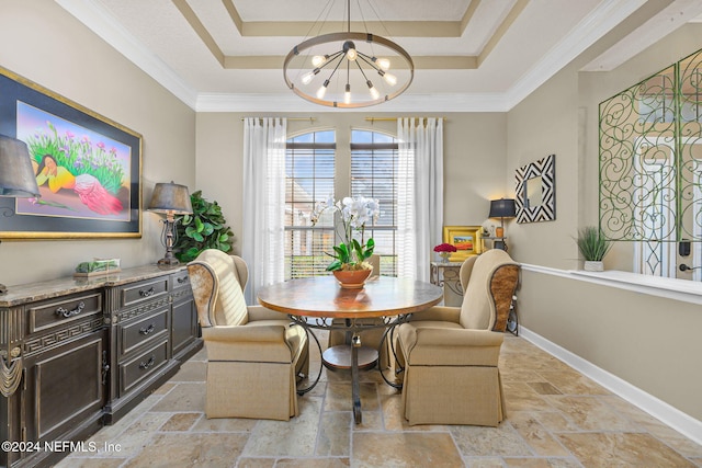 dining room featuring a tray ceiling, ornamental molding, and an inviting chandelier