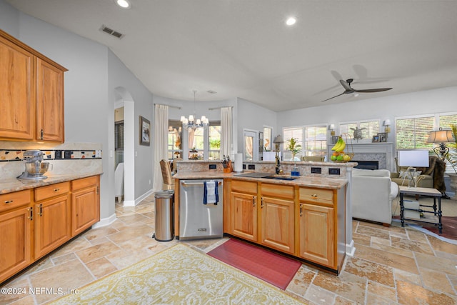 kitchen featuring decorative backsplash, ceiling fan with notable chandelier, sink, pendant lighting, and dishwasher