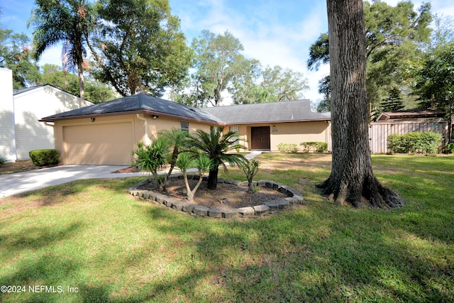 ranch-style home featuring a garage and a front yard