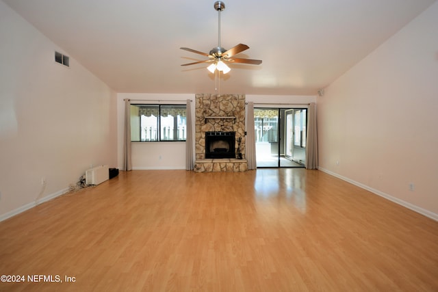 unfurnished living room featuring wood-type flooring, ceiling fan, and plenty of natural light