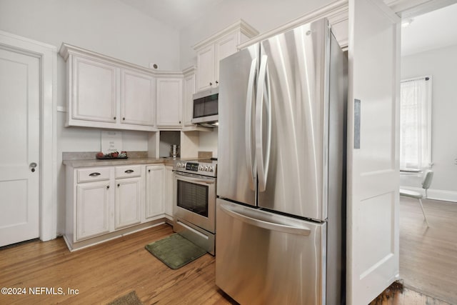 kitchen featuring white cabinetry, appliances with stainless steel finishes, and light wood-type flooring